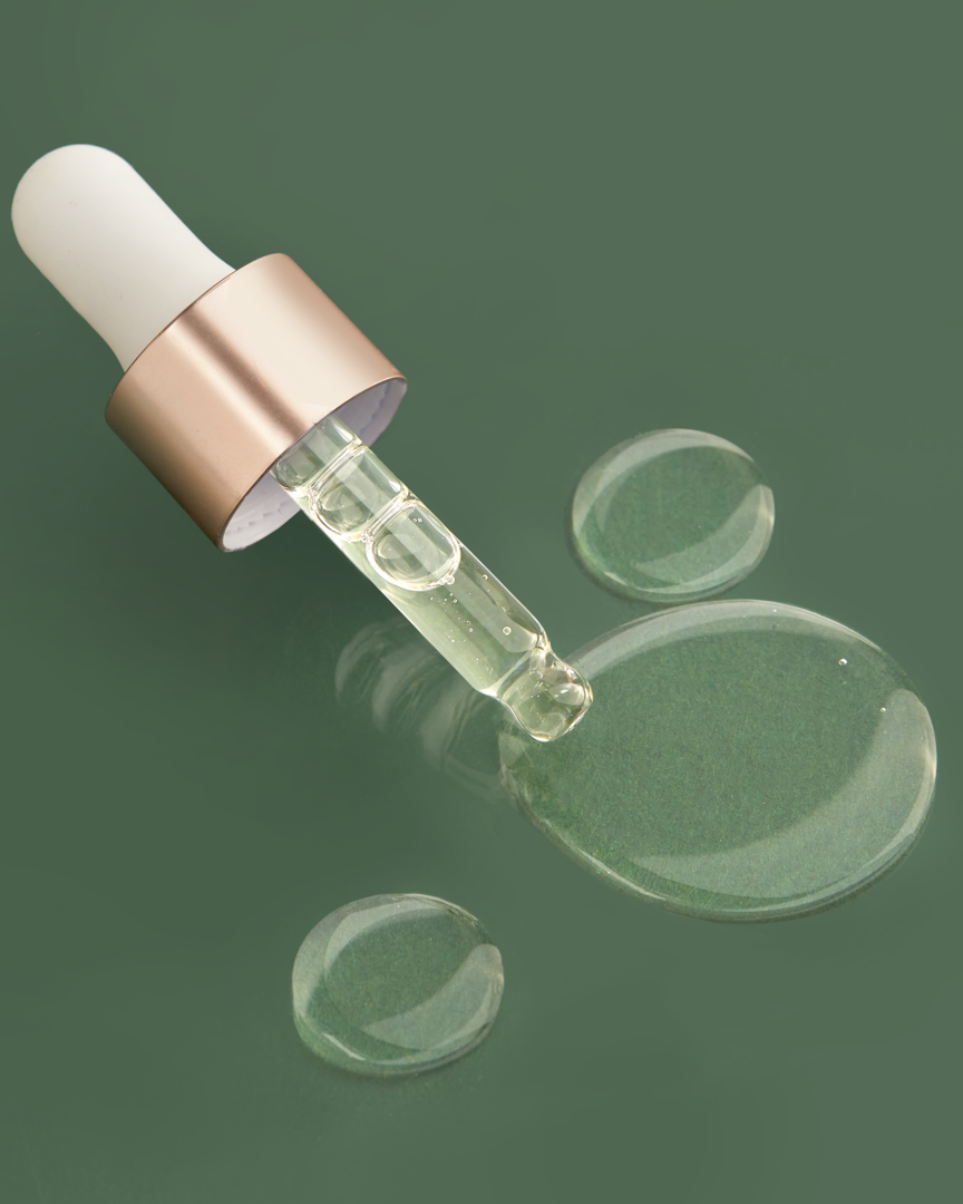 An IREN Shizen glass bottle with a DROP OF DEW Moisturizing Facial Oil on a green surface, showcasing Japanese skincare. #all-groups