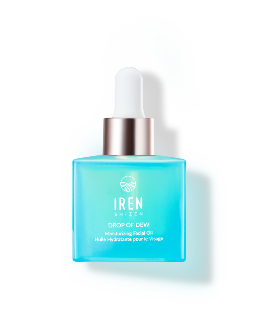 A bottle of DROP OF DEW Moisturizing Facial Oil from IREN Shizen, a Japanese skincare brand, on a black background.
