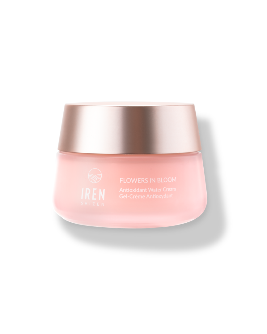 A jar of FLOWERS IN BLOOM Antioxidant Water Cream by IREN Shizen, designed for sensitive skin, featuring a pink container and a metallic cap, isolated on a white background.