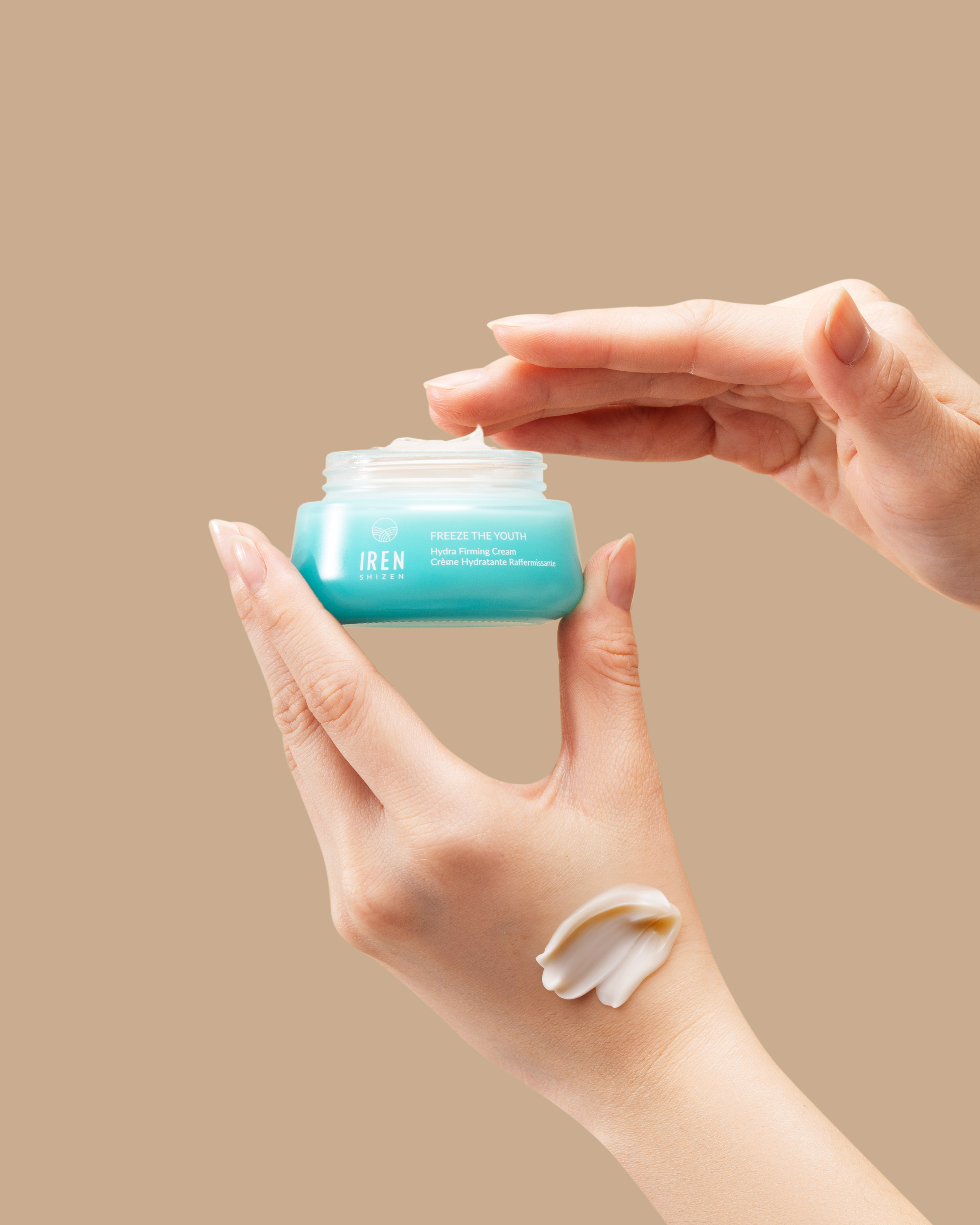A person holding a jar of FREEZE THE YOUTH Hydra Firming Cream by IREN Shizen. #all-groups