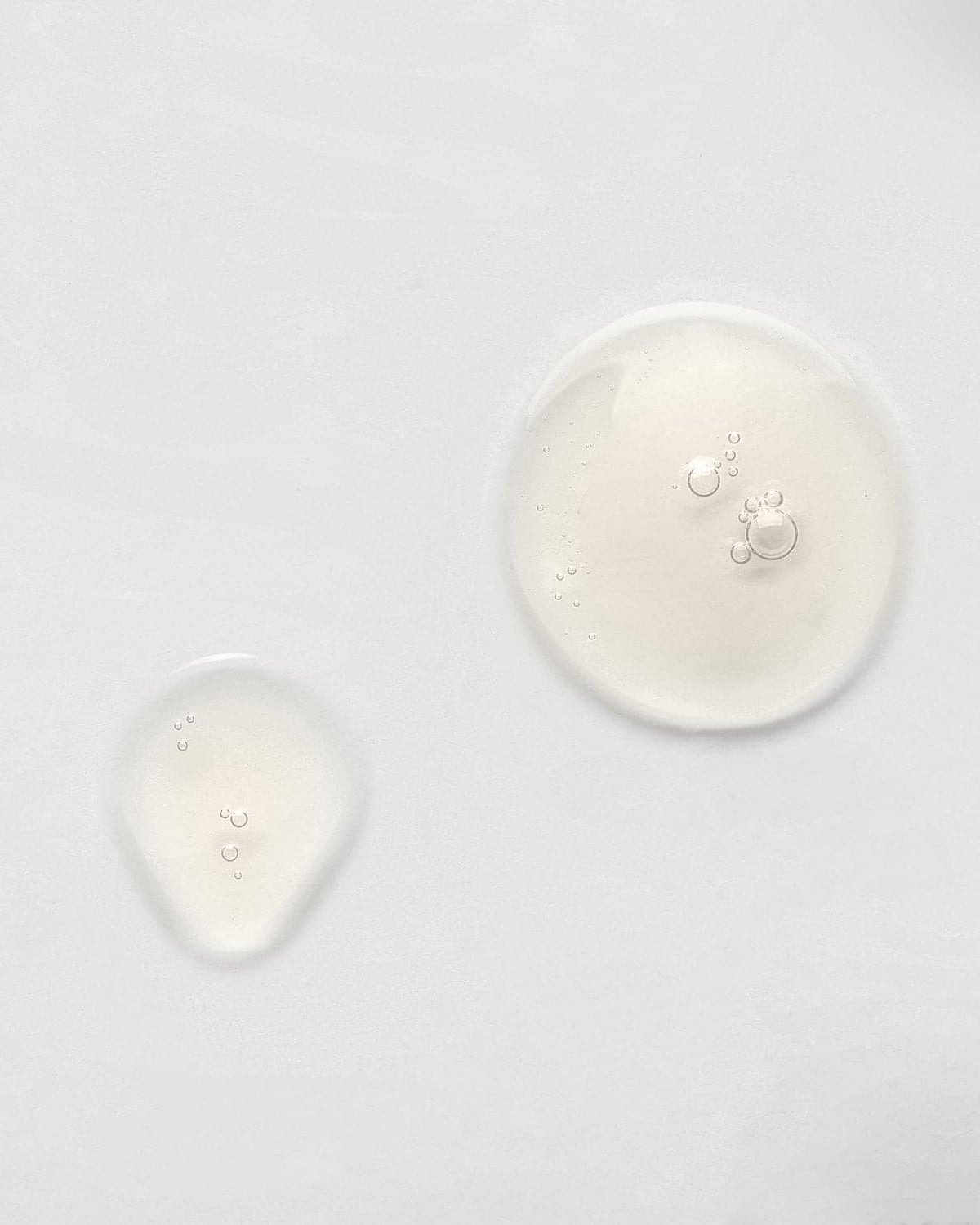 A group of custom skincare IREN Shizen KEEP CALM Soothing Serum circles on a white surface.