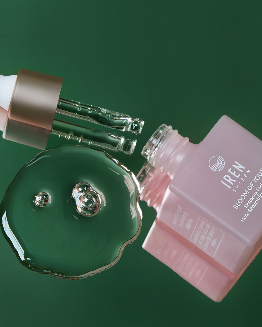 A bottle of IREN Shizen BLOOM OF YOUTH Restoring Facial Oil, customized Japanese skincare, on a green background. #all-groups