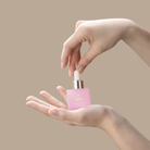 A woman's hand holding a small bottle of BLOOM OF YOUTH Restoring Facial Oil, a customized Japanese skincare product by IREN Shizen. #all-groups