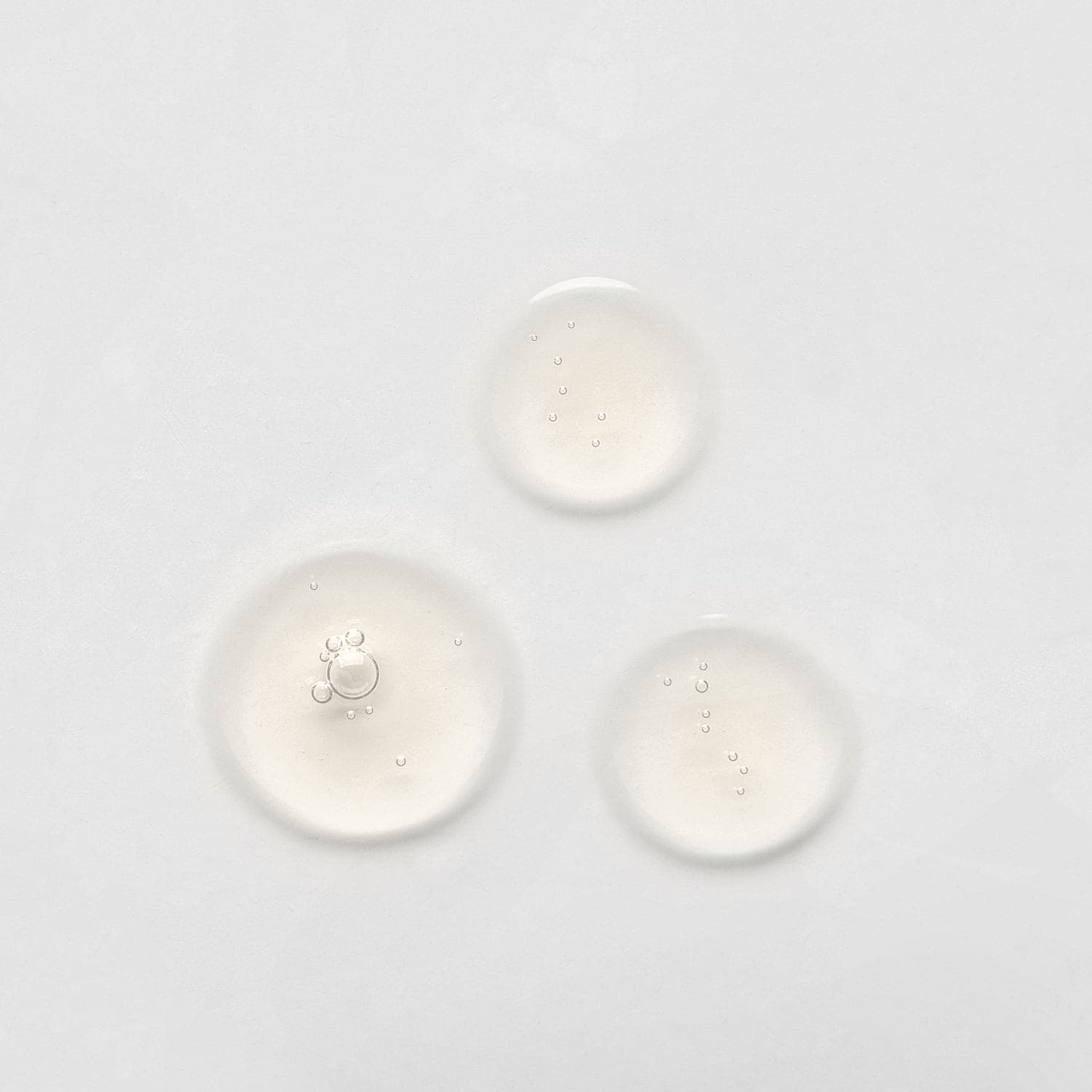 Three drops of BEST SUSTAINABLE DUO By L'OFFICIEL Beauty Awards 2023 by IREN Shizen on a white surface.