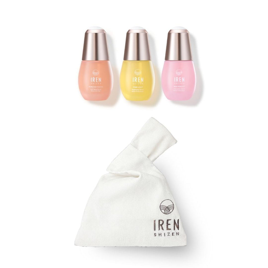 The IREN Shizen GLOW UP Anti-Aging Set, including three bottles of nail polish and a bag, featuring ageless beauty.