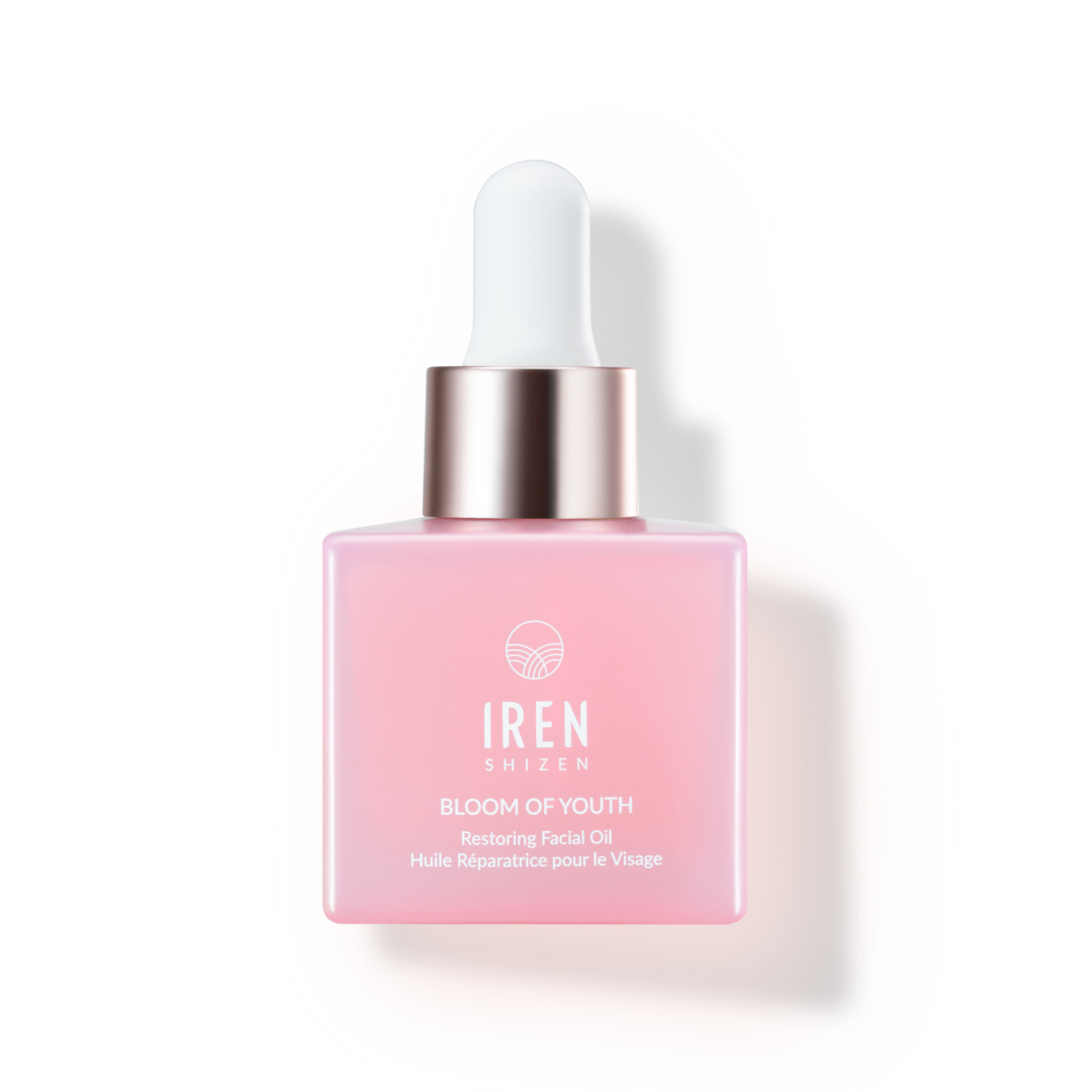 A bottle of IREN Shizen's BLOOM OF YOUTH Restoring Facial Oil, a Japanese skincare product, on a white background.