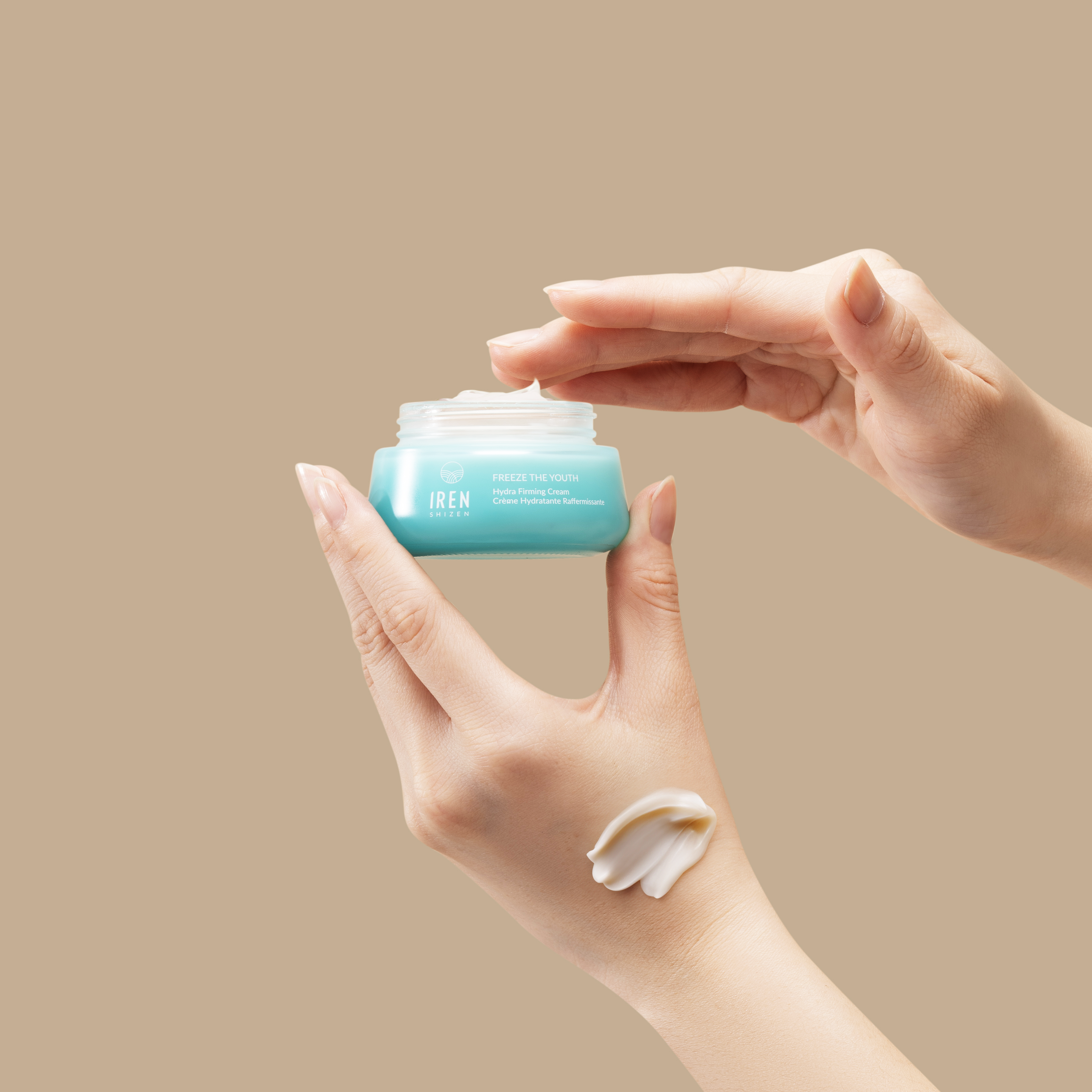 A person holding a jar of FREEZE THE YOUTH Hydra Firming Cream by IREN Shizen. #all-groups