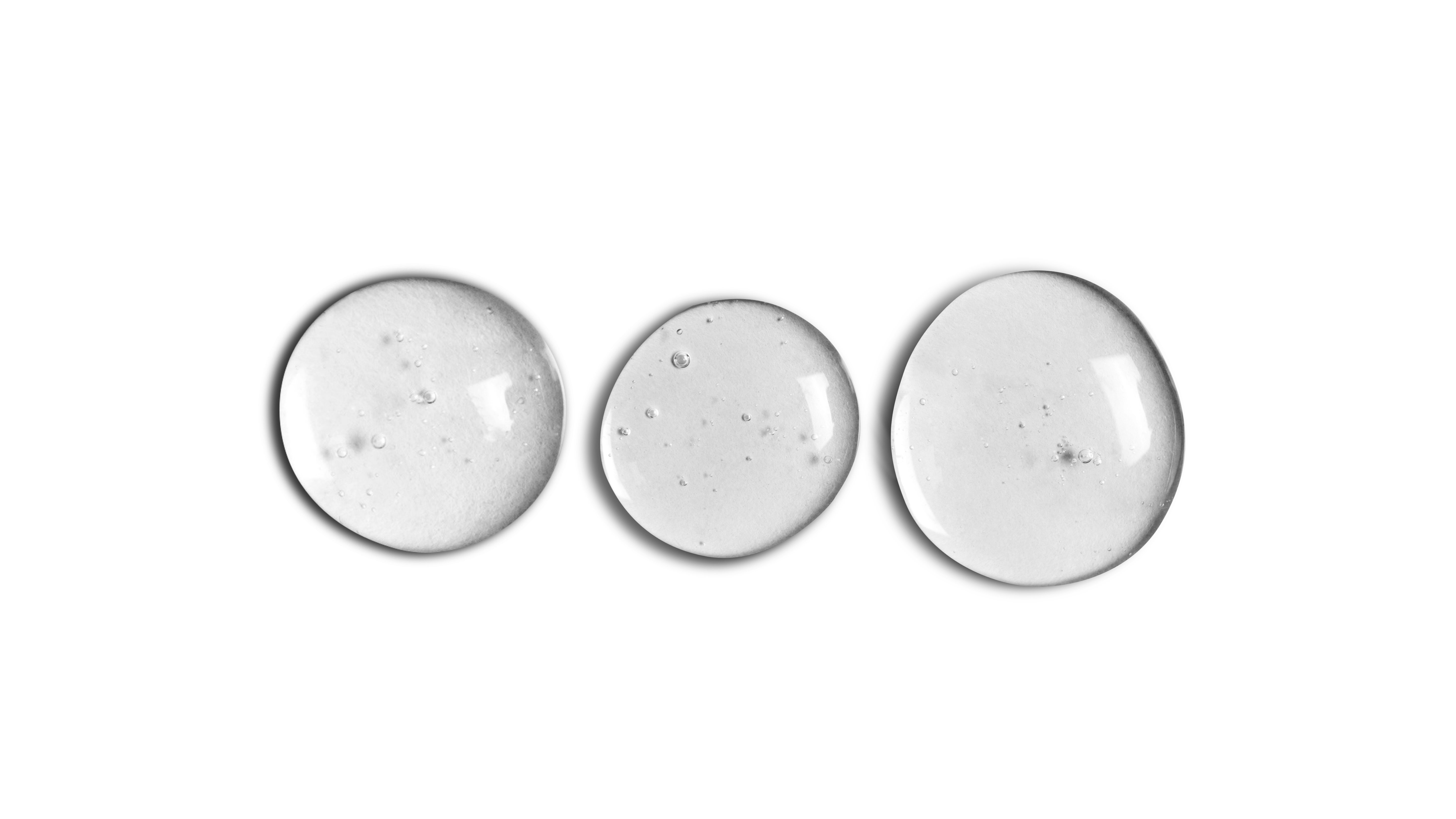 A black and white photo of three GLOW UP Facial Oil + Serums from onsen skincare on a white background.